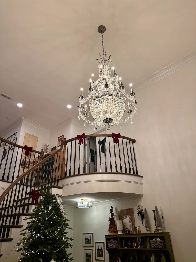 Crystal chandelier installed in two-story entryway